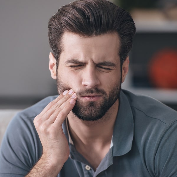 A man is experiencing tooth pain