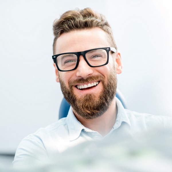 Man is happily smiling while sitting in the chair