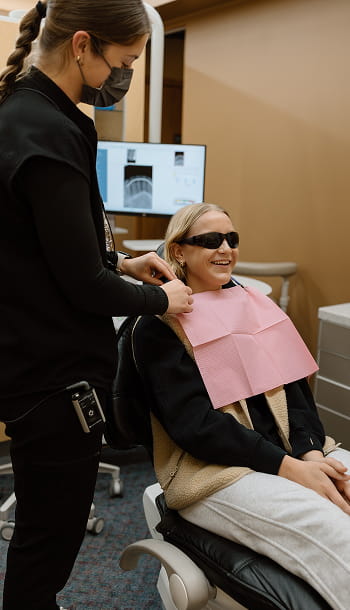 Dentist caring for her patient in a dental chair