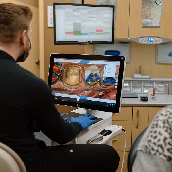 Dentist looking at monitor