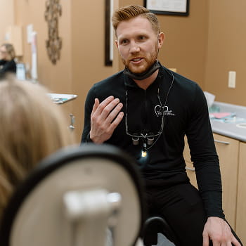 Local dentist is happily smiling at front desk