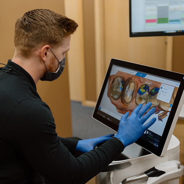 Dental tech in hand at Luverne Family Dental