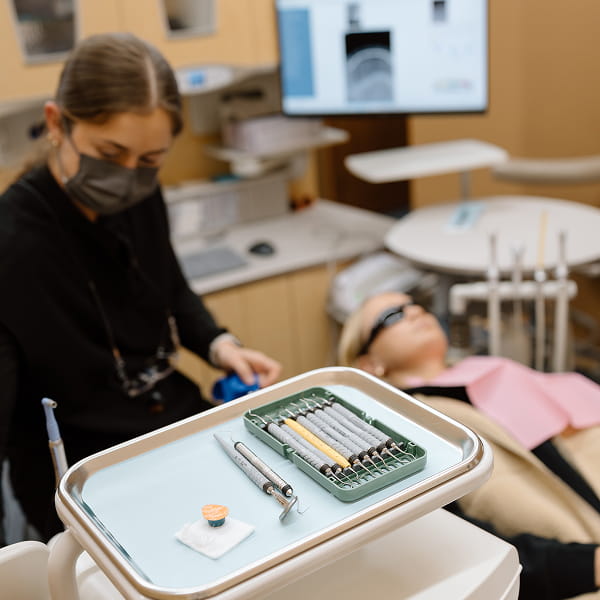 Local dentist with a Luverne patient in a dental chair with dental tools in focus