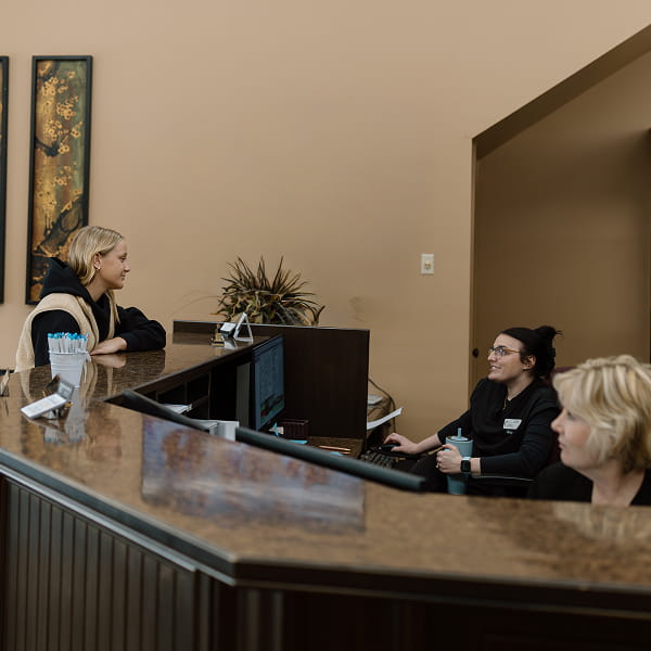 People smiling at dental reception